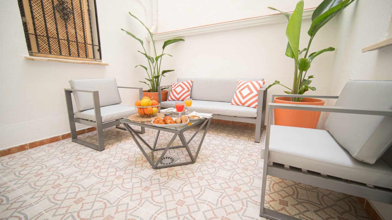 Patio privado de Boabdil Suites con mesa y plantas